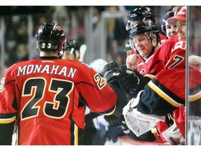 Sean Monahan of the Calgary Flames skates to the bench after scoring his second goal of the game against the Winnipeg Jets during the third period at the Saddledome in this file photo of preseason action October 2, 2014.