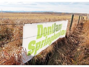 Signs supporting the DontDamnSpringbank.org movement are posted on fences along Springbank Road. The area is near the proposed Springbank dam and reservoir, and residents are trying the fight the province’s plan.