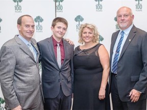 All smiles, from left, are Peter the Plantman’s Peter and Lori Hughes with their son Nickolas and Wood’s Homes director Peter Wittig.