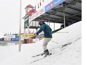 Spruce Meadows Competitions Manager Jon Garner takes advantage of a summer snow storm by skiing the south bank in the International Ring on Tuesday, a day before The Masters tournament begins. Workers have cleared the snow from the ring and the competition will be a go.