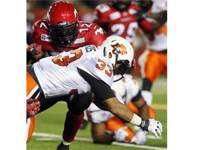 Stampeders line backer Juwan Simpson helps to bring down Lions running back Andrew Harris in the second half as the Calgary Stampeders went on to a 14-7 win over their West Division rivals.