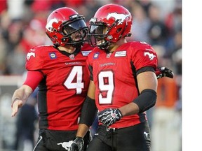 Stampeders quarterback Drew Tate, left, and running back Jon Cornish celebrate a touchdown during a win over the Toronto Argos at McMahon Stadium two weeks ago. They duo are reunited in the starting lineup Saturday against the B.C. Lions.