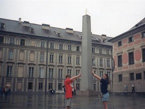 Ageless joke: A monolith at the Prague Castle gets a helping hand.