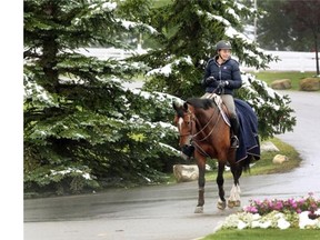 Swiss equestrian rider Nadja Peter Steiner rode Celeste past some snow covered trees at Spruce Meadows on Tuesday. More heavy snow on Wednesday forced the postponement of the opening day’s events of the Masters tournament, which will now begin on Thursday instead.
