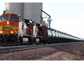 This Nov. 6, 2013, file photo shows a BNSF Railway train hauling crude oil near Wolf Point, Mont. Thousands of older rail tank cars that carry crude oil would be phased out in the U.S. within two years under regulations proposed in response to a series of fiery train crashes over the past year.
