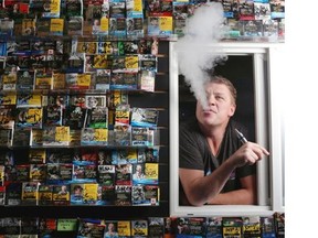 Travis Gerlitz smokes an e-cigarette at his shop Global Haze Electric Cigarette on Wednesday. Gerlitz is concerned that the lack of government regulations means some distributors don’t take proper care to ensure the safety of their products.