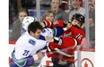 Vancouver Canucks tough guy Tom Sestito and Calgary Flames bruiser Brian McGrattan square off during a game last season at the Saddledome. The Flames are helping their players protect themselves by using a fighting coach.