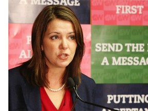 Wildrose leader Danielle Smith, in Calgary on October 6, 2014, says Alberta premier Jim Prentice’s promise on political staffers severance pay does not go far enough.