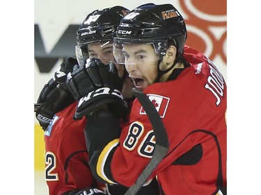 Josh Jooris of the Calgary Flames celebrates their first goal of the game with Paul Byron during game action against the Arizona Coyotes at the Saddledome in Calgary, on November 13, 2014.