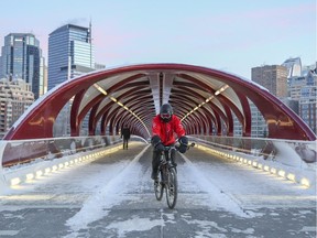 Commuters, walkers and bikers, cross the Peace Bridge at the end of a cold workday in downtown Calgary, on November 14, 2014.