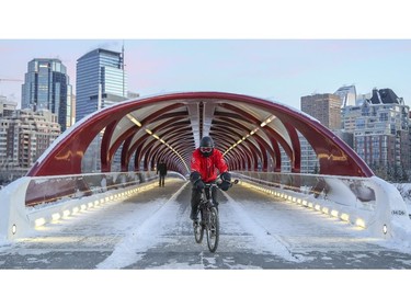 Commuters, walkers and bikers, cross the Peace Bridge at the end of a cold workday in downtown Calgary, on November 14, 2014.