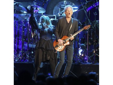 Stevie Nicks, left, dances to the guitar solo of Lindsey Buckinghamon on stage at Fleetwood Mac's On With the Show tour stops at the Saddledome in Calgary, on November 14, 2014.