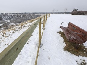 A fence is being built along an escarpment overlooking the Elbow River near Britannia.