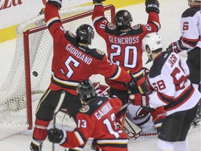 The Calgary Flames celebrate a goal during the third period against the New Jersey Devils at the Scotiabank Saddledome in Calgary, on November 22, 2014.