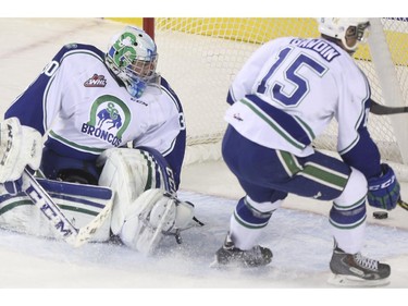 Swift Current Bronco goalie Landon Bow couldn't keep this one out during Western Hockey League action against the Swift Current Broncos at the Scotiabank Saddledome in Calgary, on November 28, 2014.