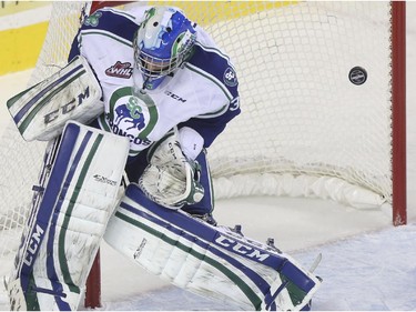 Swift Current Broncos goalie Landon Bow lets this one get by during Western Hockey League action against the Calgary Hitmen at the Scotiabank Saddledome in Calgary, on November 28, 2014.