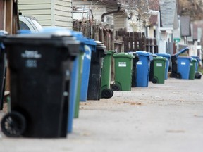 Green box composting boxes are lined up for pick-up with black garbage and blue recycling boxes in Abbeydale on Thursday May 15, 2014.