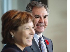Alberta Premier Jim Prentice, right, and B.C. Premier Christy Clark laugh during a news conference after a meeting at the premier's office in Vancouver, on Monday, Nov. 3, 2014.