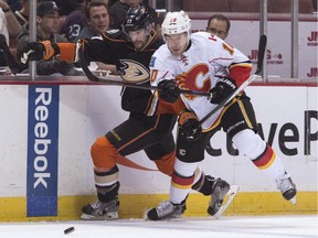 Anaheim Ducks' Ryan Kesler, left, tries to drive the puck past Calgary Flames' Corban Knight during an NHL hockey game Tuesday, Nov. 25, 2014, in Anaheim, Calif.