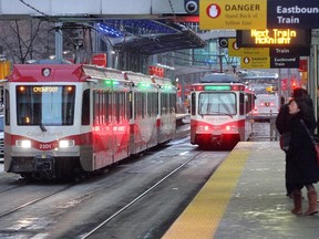 People wait on the platform to board a Calgary CTrain.