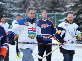Premier of Alberta Jim Prentice, middle, plays ball hockey outside the Banff Springs Hotel in Banff on November 14, 2014.