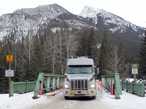 A truck from Exshaw rumbles across the restricted access to the town of Banff's waste disposal site in January 2014. The Town of Canmore will now be allowed to truck its waste to the facility after Parks Canada approved it.