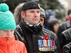 Retired British Military member Steve Rook stood and listened as crowds gathered at the Central Memorial Park Cenotaph in Calgary on November 11, 2014 for a Remembrance Day service.