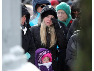 Heather Agren wiped away a tear after her daugher laid a wreath at the Cenotaph for her grandfather as crowds gathered at the Central Memorial Park monument for a Remembrance Day service on November 11, 2014.