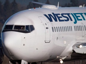 A pilot taxis a Westjet Boeing 737-700 plane to a gate after arriving at Vancouver International Airport on February 3, 2014.