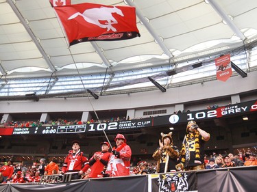 Fans watch the Stampeders and Tiger Cats warm up in B.C. Place before the 2014 Grey Cup in Vancouver on Sunday November 30, 2014.