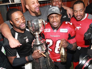 The Calgary Stampeders celebrate with the Grey Cup in the locker room after winning the 2014 in CFL championship Vancouver on Sunday November 30, 2014.