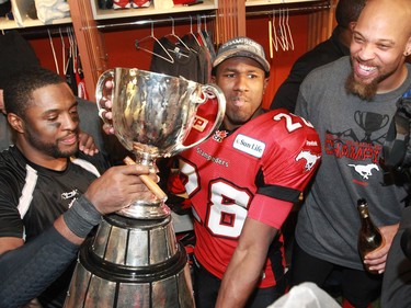 The Calgary Stampeders celebrate with the Grey Cup in the locker room after winning the 2014 in CFL championship Vancouver on Sunday November 30, 2014.