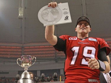 The Calgary Stampeders quarterback Bo Levi Mitchell holds his Grey Cup MVP award after winning the 2014 Grey Cup in Vancouver on Sunday November 30, 2014.