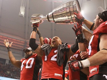 The top of the Grey Cup breaks off as Juwan Simpson raises it over his head after the team won the 2014 Grey Cup in Vancouver on Sunday November 30, 2014.