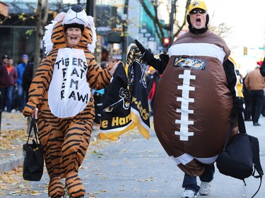 Hamilton Tiger Cats fans walk towards B.C. Place for the 2014 Grey Cup in Vancouver on Sunday November 30, 2014.