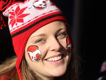 Stamps fan Danielle Ewing from Calgary smiles after getting her face painted in team colours before the 2014 Grey Cup in Vancouver on Sunday November 30, 2014.