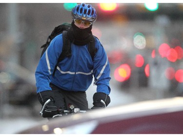A downtown cyclist rides the 7th Street SW dedicated lane at rush hour Wednesday November 12, 2014.
