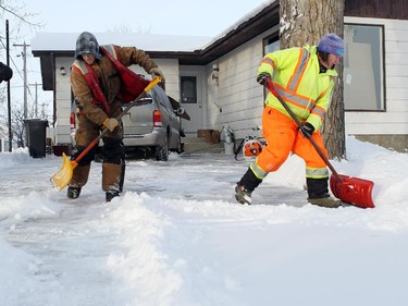 Matthew Baron, Ryan Baraniuk and Becky Melnechuk of Farmboy Lawn maintenance  in High River were out bright and early clearing snow out of driveways in High River after a snow storm left most of Alberta blanketed in snow and bone chilling temperatures.