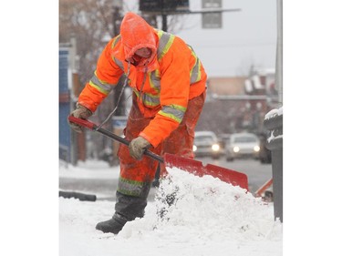 Dylan Brill braves the bitter cold shovelling a section of sidewalk on 9th Avenue SE in Inglewood Friday morning November 28, 2014 as the wind chill hovered around minus 30 celcius.