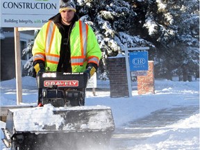 Alex Sparks embraces Calgary's deep chill as he cleans sidewalks in the NE on Nov. 30.