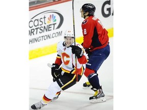Calgary Flames centre Sean Monahan celebrates his game-winning goal in the overtime period as Washington Capitals superstar Alex Ovechkin skates behind him.