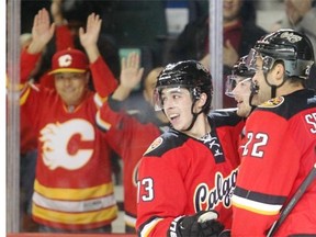 Calgary Flames fan favourite Johnny Gaudreau celebrates a goal against the Nashville Predators with linemates Devin Setoguchi and Paul Byron last Friday.