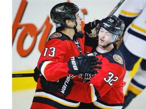 Calgary Flames rookie Johnny Gaudreau, left, celebrates a goal with teammate Paul Byron against the Nashville Predators.