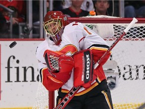 CHICAGO, IL - OCTOBER 15: Jonas Hiller #1 of the Calgary Flames makes a save against the Chicago Blackhawks at the United Center on October 15, 2014 in Chicago, Illinois. The Flames defeated the Blackhawks 2-1 in overtime.