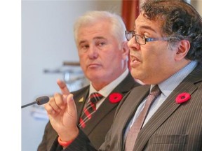 Calgary mayor Naheed Nenshi, right, and Coun. Ward Sutherland discuss the city’s proposed four-year budget on Tuesday.