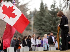 Juno Beach Academy student honour guard during the No Stone Left Alone ceremony where Canadian Forces soldiers and students place poppies on all military gravesides at the Burnsland Cemetery in Calgary On november 6, 2014.
