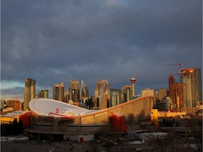 The sun rises over the Saddledome on a November morning.