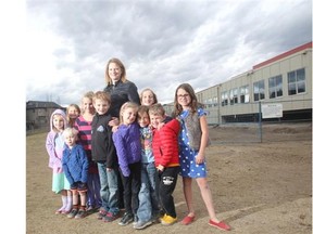 CALGARY, AB.; OCTOBER 31, 2014 — Parent Jan Nicholson gathers with a group of youngsters from West Springs School in front of 2 new modular classrooms on Friday October 31, 2014. She says the portables will help alleviate the space crunch at the school. (Ted Rhodes/Calgary Herald) For City story by Trevor Howell