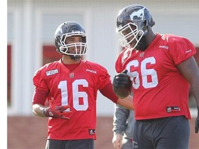 Calgary Stampeders slot back Marquay McDaniel, left, chats with offensive lineman Stanley Bryant as they practise with the team in advance of their game against the B.C. Lions on Friday.