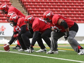 Calgary Stampeders offensive line going through various drills during Thursday's morning practice at McMahon Stadium as they prepare for Sunday's CFL West Final.